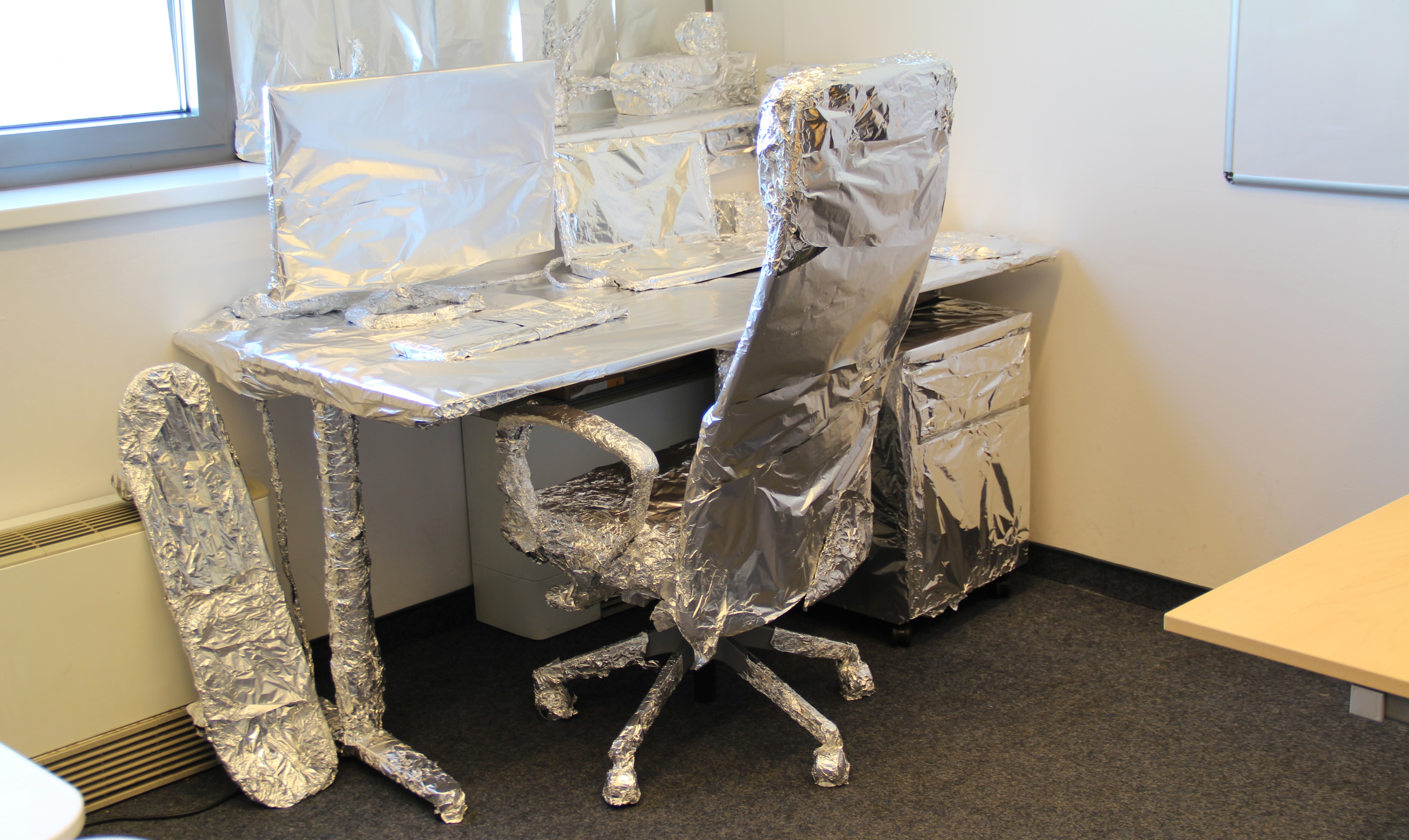 Arenim team birthday prank on a developer colleague — desk wrapped up as a joke, 2016